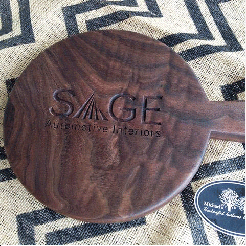 Corporate logo engraved handcrafted round-cutting-board walnut Michael's Woodcraft Greenville SC South Carolina buy cutting board charcuterie board business awards corporate gifts logo engraving Sage Automotive
